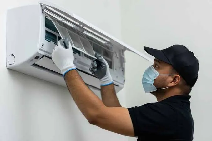 AC cleaning in Dubai's climate – technician servicing a coastal apartment's AC unit